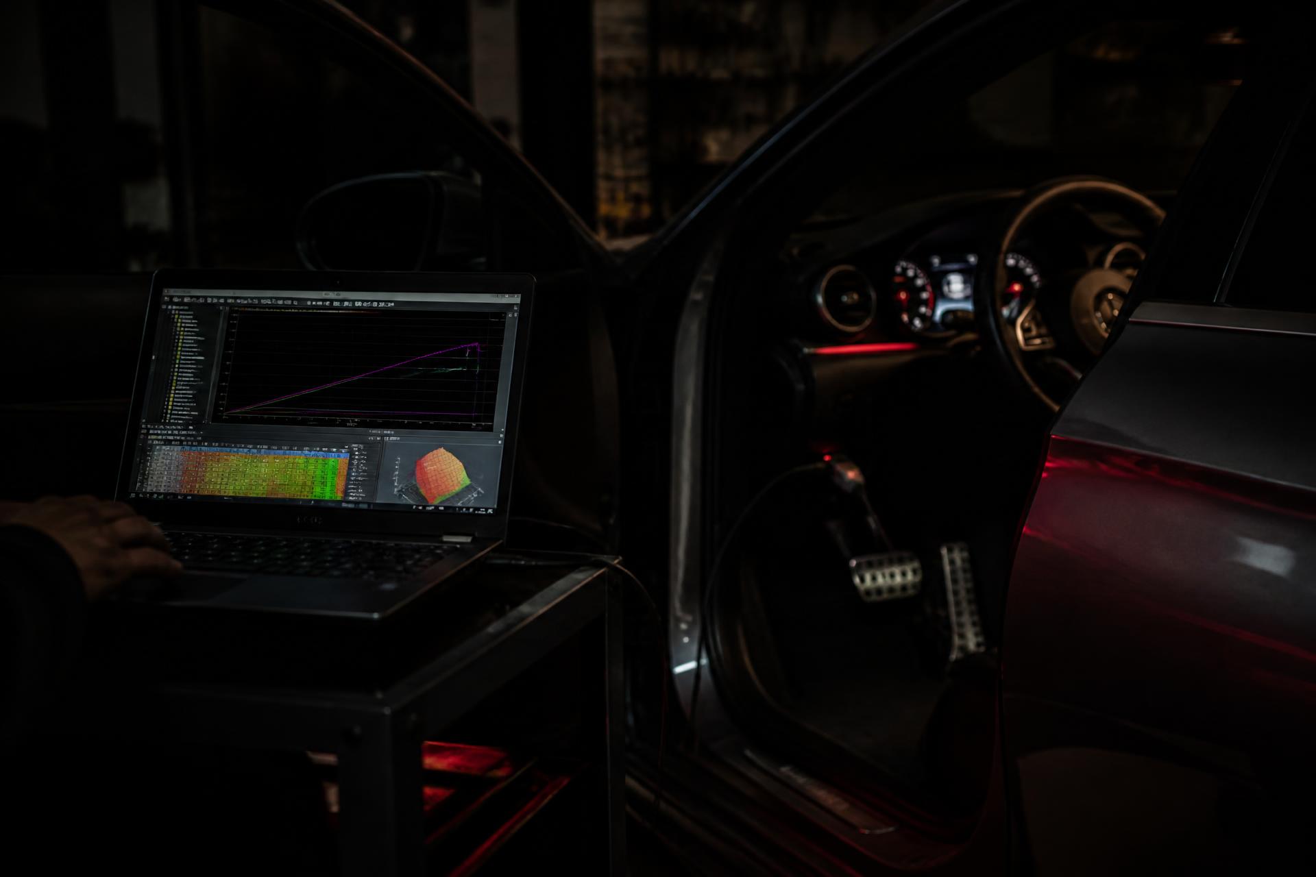ECU diagnostics laptop tuning a car at night